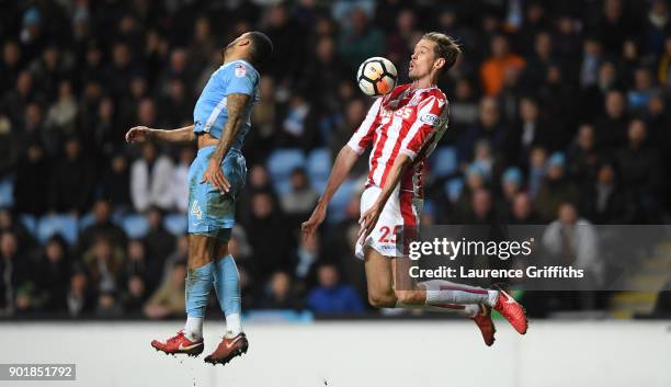 Peter Crouch of Stoke City wins a header from Jordan Willis of Coventry City during the The Emirates FA Cup Third Round match between Coventry City...