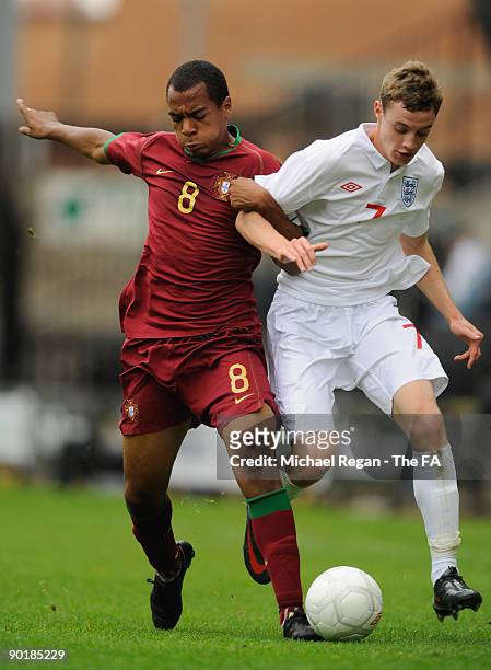 Joao Mario of Portugal tackles William Keane of England during the international match between England U17 and Portugal U17 at Meadow Lane on August...