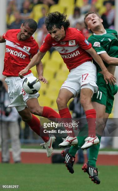 Rafael Karioka and Sergey Kovalchuk of FC Spartak Moscow battles for the ball with Alexander Bukharov of FC Rubin Krazan during the Russian Football...