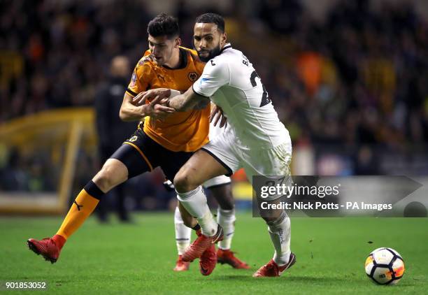 Wolverhampton Wanderers' Nouha Dicko and Swansea City's Kyle Bartley battle for the ball during the FA Cup, third round match at Molineux Stadium,...