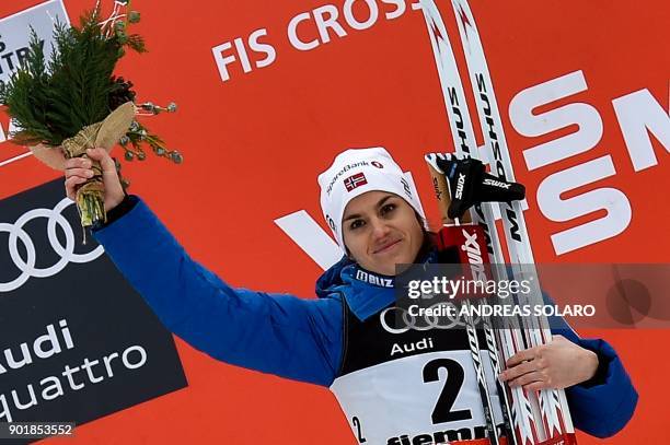 Winner Norway's Heidi Weng celebrates on the podium during the price ceremony, after competing in the Women's Cross Country 10 km Mass Start Classic...