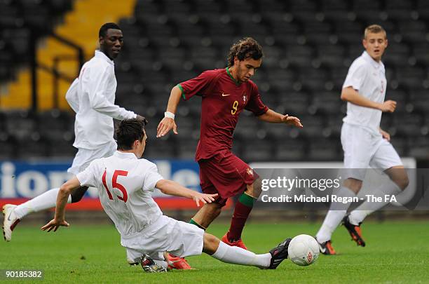 Rui Silva of Portugal is tackled by Tom Thorpe of England during the international match between England U17 and Portugal U17 at Meadow Lane on...
