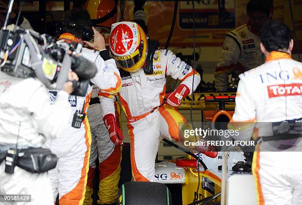 Renault's Spanish driver Fernando Alonso gets out of his car after he retired, in the pits of the Spa-Francorchamps Circuit on August 30, 2009 in...