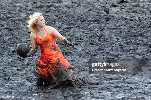 Participant of the fashion show throws a ball during the Mudflat Olympic Games on August 30, 2009 in Brunsbuttel, Germany.