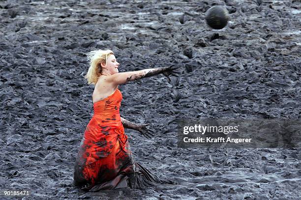 Participant of the fashion show throws a ball during the Mudflat Olympic Games on August 30, 2009 in Brunsbuttel, Germany.