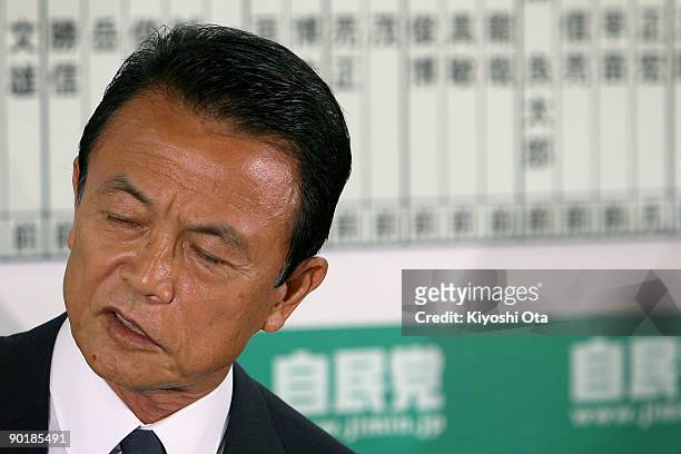 Prime Minister and President of the Liberal Democratic Party Taro Aso reacts as he speaks to the media during the Lower House Election at the party's...