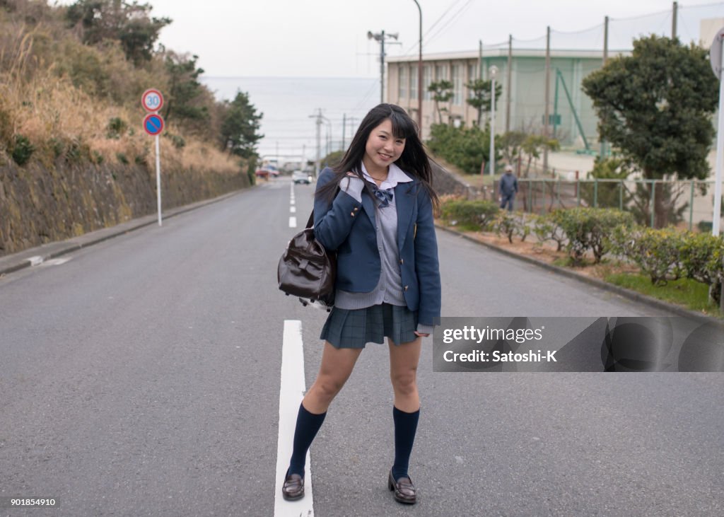 High school student girl standing on slope