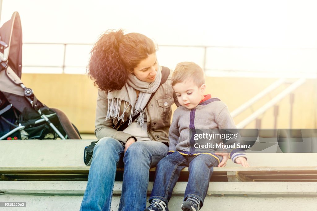 Mother talking to her son sitting
