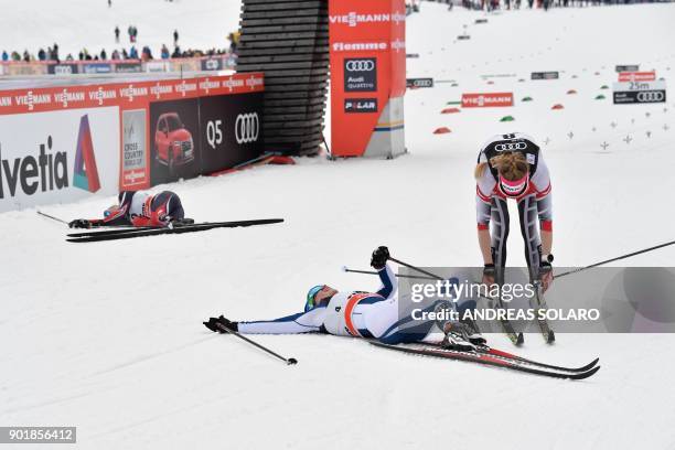 Winner Norway's Heidi Weng , second-placed Finland's Krista Parmakoski and third-placed Austria's Teresa Stadlober react in the finish area, after...