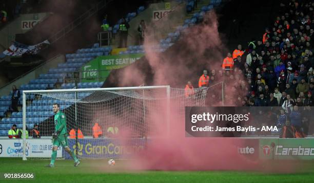 Flare lands near Liam O'Brien of Coventry City during The Emirates FA Cup Third match between Coventry City and Stoke City at Ricoh Arena on January...