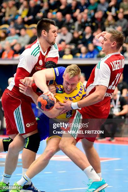 Sweden's Fredric Pettersson , Hungary's Bence Banhidi and Patrik Ligetvari vie during a friendly handball match between Sweden and Hungary at Kinnarp...