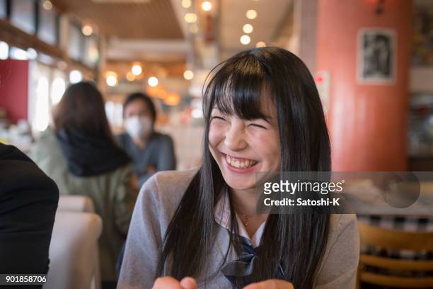 high school student girl smiling in cafe - female high school student stock pictures, royalty-free photos & images