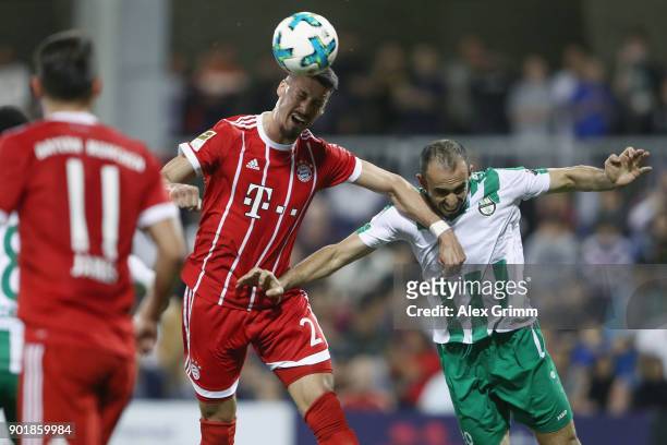 Sandro Wagner of Muenchen jumps for a header with H. Masri of Al Ahli during the friendly match between Al-Ahli and Bayern Muenchen on day 5 of the...
