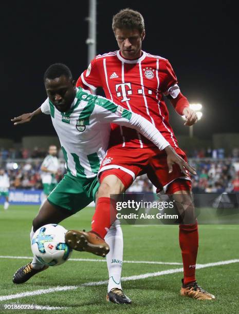 Thomas Mueller of Muenchen is challenged by John Benson of Al Ahli during the friendly match between Al-Ahli and Bayern Muenchen on day 5 of the FC...