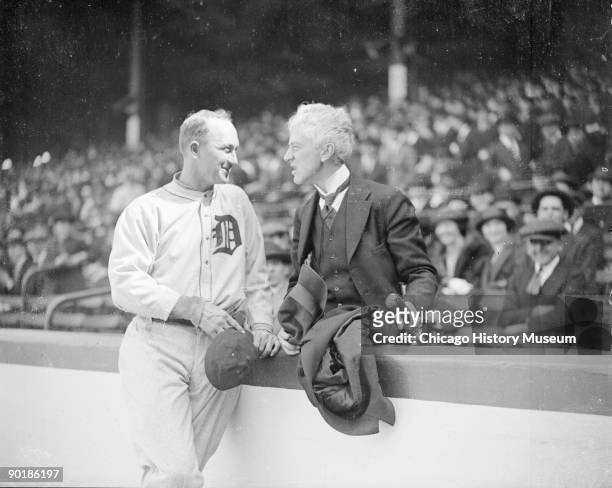 Informal full-length portrait of baseball player Ty Cobb of the American League's Detroit Tigers, standing with Judge Kenesaw Mountain Landis ,...