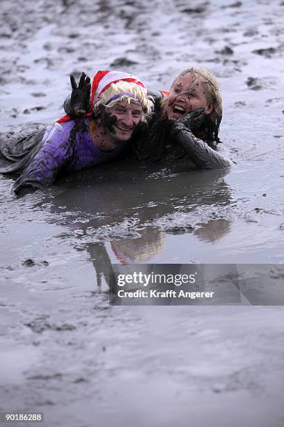 Participants pose after the football match during the Mudflat Olympic Games on August 30, 2009 in Brunsbuttel, Germany.