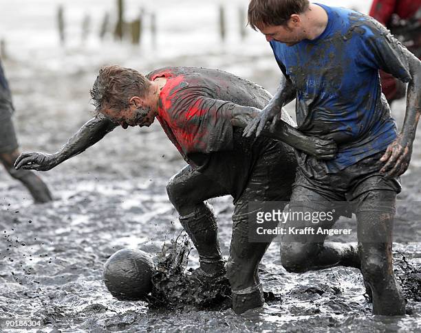 Participants play football during the Mudflat Olympic Games on August 30, 2009 in Brunsbuttel, Germany.