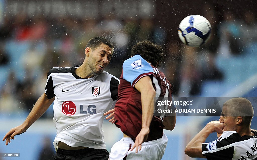 Fulham's US player Clint Dempsey (L) hea