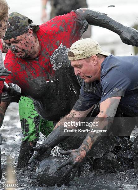 Participants play football during the Mudflat Olympic Games on August 30, 2009 in Brunsbuttel, Germany.