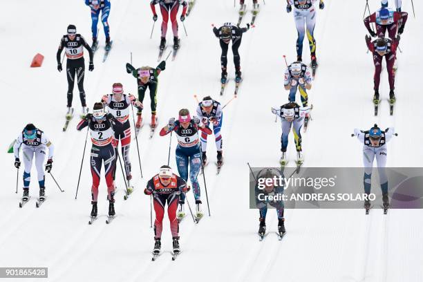 Skiers compete in the Women's Cross Country 10 km Mass Start Classic race of the FIS World cup Tour de Ski at Val Di Fiemme Cross Country stadium in...