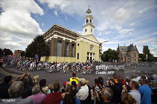 Riders pass a chrch during the Vuelta, the tour of Spain ,in the centre of Assen, on August 30, 2009. AFP PHOTO / ANP ERIK VAN 'T WOUD netherlands...