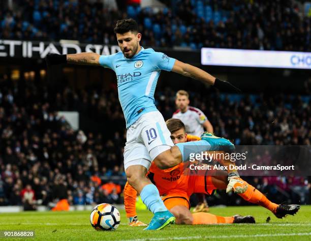 Manchester City's Sergio Aguero rounds Burnley's Nick Pope before slotting his second goal during the Emirates FA Cup Third Round match between...