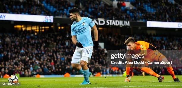 Manchester City's Sergio Aguero rounds Burnley's Nick Pope before slotting his second goal during the Emirates FA Cup Third Round match between...