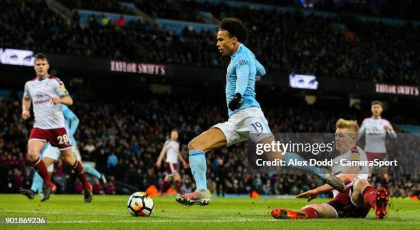 Manchester City's Leroy Sane beats Burnley's Ben Mee before slotting his side's third goal during the Emirates FA Cup Third Round match between...