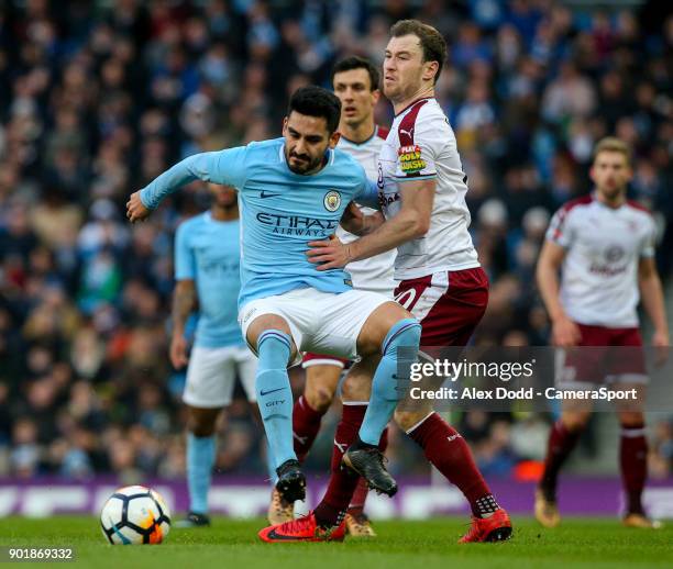 Burnley's Ashley Barnes battles with Manchester City's Ilkay Gundogan during the Emirates FA Cup Third Round match between Manchester City and...