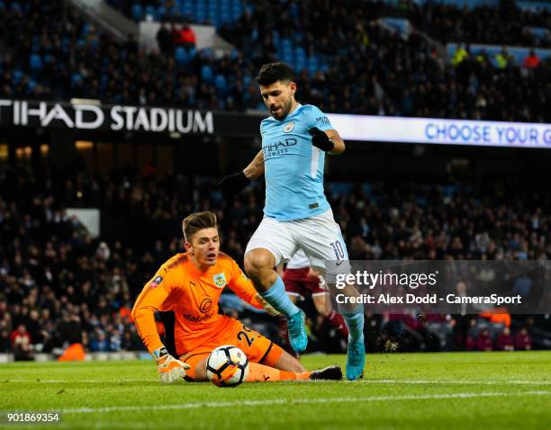 Manchester City's Sergio Aguero rounds Burnley's Nick Pope before slotting his second goal during the Emirates FA Cup Third Round match between...