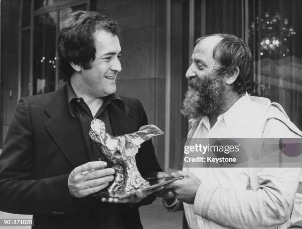 Italian film director Bernardo Bertolucci with the Raoul Levy prize awarded to him for 'Last Tango in Paris', 4th May 1973. On the right is French...