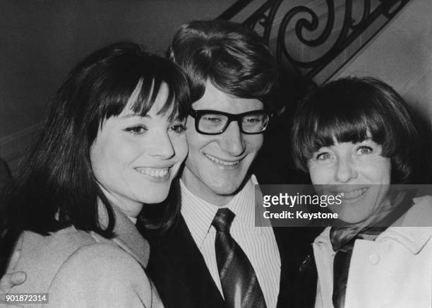 French fashion designer Yves Saint Laurent with fashion models Elsa Martinelli and Bettina Graziani after his Spring-Summer 1966 fashion show in...