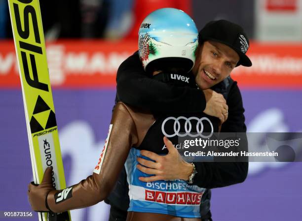 Former ski jumper Sven Hannawald of Germany congrats Kamil Stoch of Poland after the FIS Nordic World Cup Four Hills Tournament on January 6, 2018 in...
