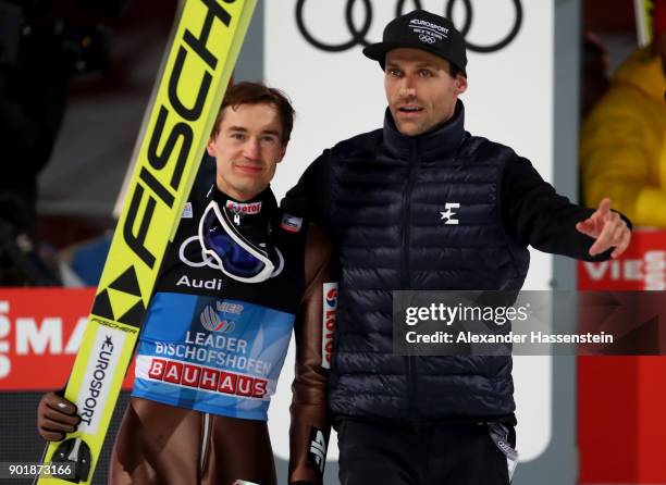 Former ski jumper Sven Hannawald of Germany congrats Kamil Stoch of Poland after the FIS Nordic World Cup Four Hills Tournament on January 6, 2018 in...