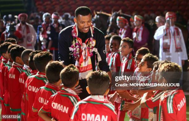 Omani goalkeeper Faiz al-Rushaidi walks among children during a celebration ceremony to welcome Oman's national football team after they won the 23th...