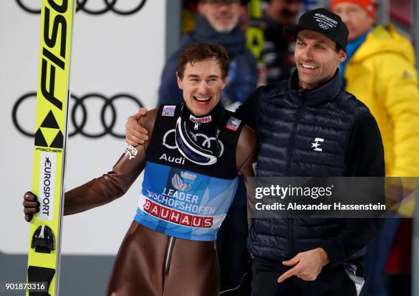 Former ski jumper Sven Hannawald of Germany congrats Kamil Stoch of Poland after the FIS Nordic World Cup Four Hills Tournament on January 6, 2018 in...