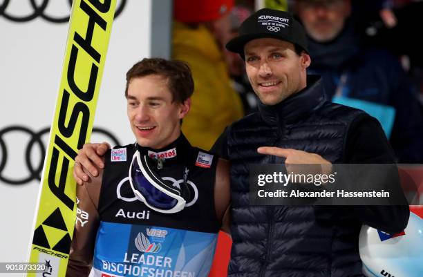 Former ski jumper Sven Hannawald of Germany congrats Kamil Stoch of Poland after the FIS Nordic World Cup Four Hills Tournament on January 6, 2018 in...