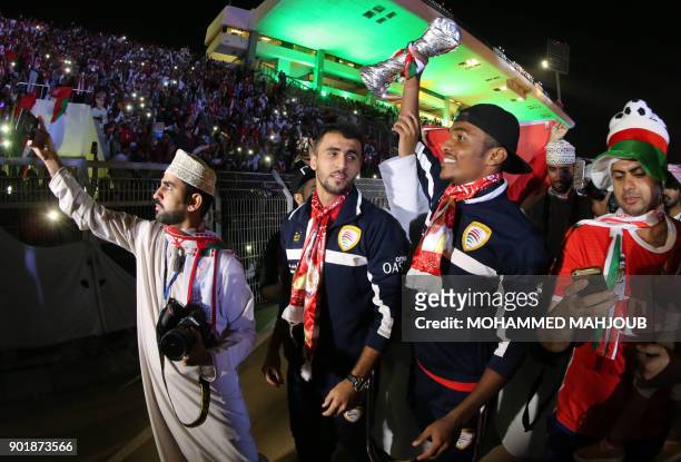 Omani fans and players attend a celebration ceremony to welcome Oman's national football team after they won the 23th Gulf Cup of Nations, in Muscat...