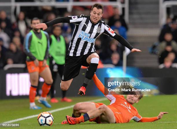 Javier Manquillo of Newcastle United is tackled by Luke Berry of Luton Town during the Emirates FA Cup Third Round match between Newcastle United and...