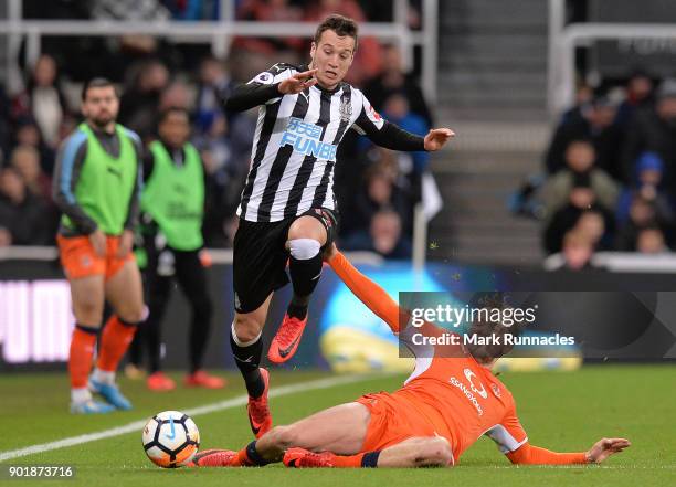 Javier Manquillo of Newcastle United is tackled by Luke Berry of Luton Town during the Emirates FA Cup Third Round match between Newcastle United and...