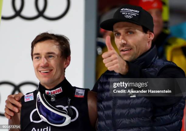 Former ski jumper Sven Hannawald of Germany congrats Kamil Stoch of Poland after the FIS Nordic World Cup Four Hills Tournament on January 6, 2018 in...