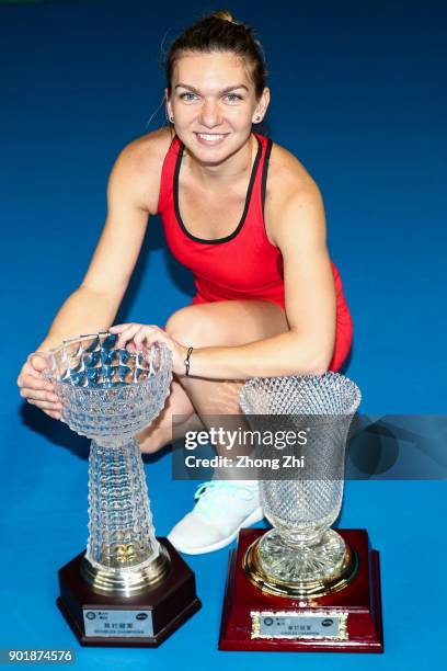 Simona Halep of Romania poses for photo with her Single and Double Champion trophy during Day 7 of 2018 WTA Shenzhen Open at Longgang International...