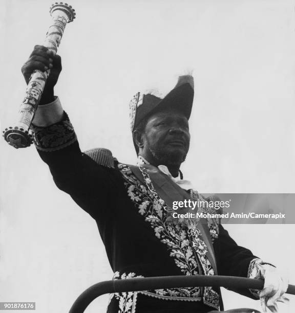 Jean-Bédel Bokassa , Emperor of Central Africa, takes the salute at a victory parade to celebrate his recent coronation, 28th December 1977.