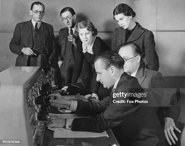 Jasmine Bligh and Elizabeth Cowell, the BBC's new announcers, learn the workings of the Dramatic Control Panel at Broadcasting House in London, 23rd...