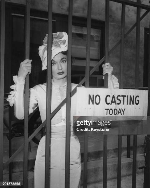 American actress Ann Blyth poses behind a sign reading 'No Casting Today' in Hollywood, California, circa 1955.