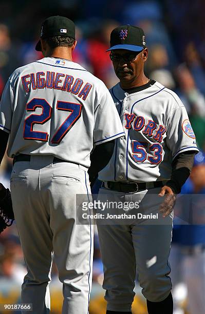 Manager Jerry Manuel of the New York Mets removes starting pitcher Nelson Figueroa from a game against the Chicago Cubs on August 30, 2009 at Wrigley...