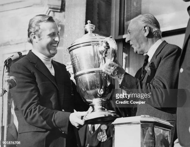 Roger Wethered presents the Walker Cup to British team captain Michael Bonallack on the Old Course at St Andrew's, Scotland, after Britain's victory...