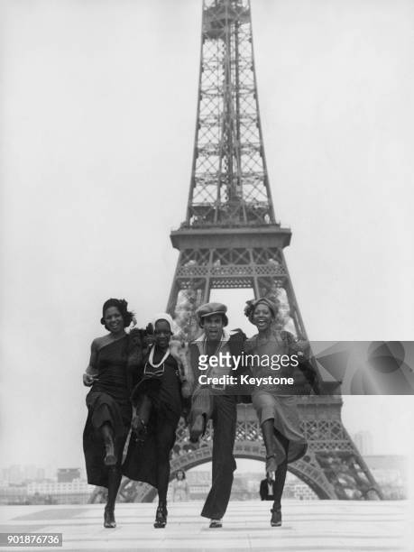 From left to right, Marcia Barrett, Maizie Williams, Bobby Farrell and Liz Mitchell of the German vocal group Boney M., in front of the Eiffel Tower...