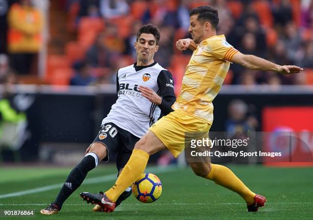 Nacho Vidal of Valencia competes for the ball with Alex Granell of Girona during the La Liga match between Valencia and Girona at Mestalla stadium on...