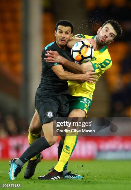 Grant Hanley of Norwich City is challenged by Pedro of Chelsea during The Emirates FA Cup Third Round match between Norwich City and Chelsea at...